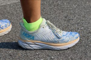 A person wearing Hoka running shoes