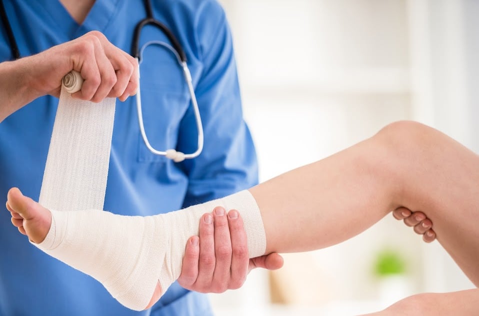 A doctor bandaging a foot