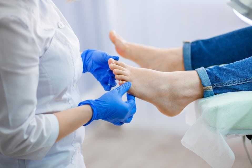 A doctor inspecting a patient's feet